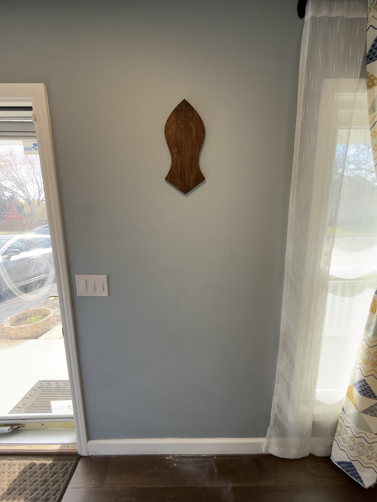 Nalayn Shareef hung on a wall in a room, for scale
